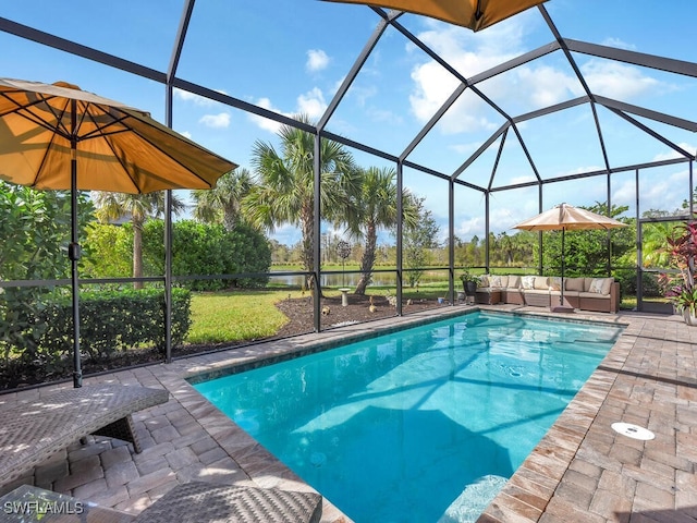 view of swimming pool featuring outdoor lounge area, a lanai, and a patio area