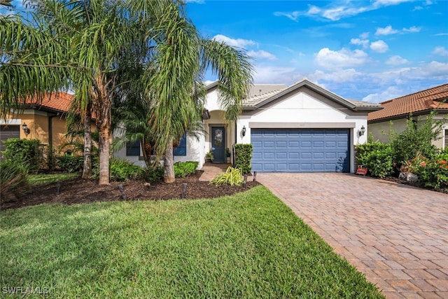 view of front of property with a garage and a front yard