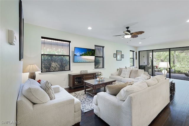 living room featuring dark hardwood / wood-style flooring and ceiling fan