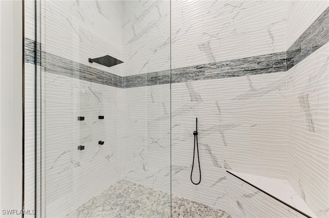 bathroom with tiled shower