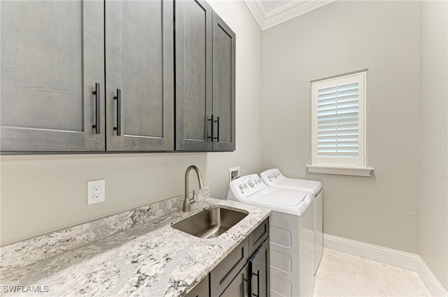 laundry area with sink, cabinets, independent washer and dryer, and crown molding