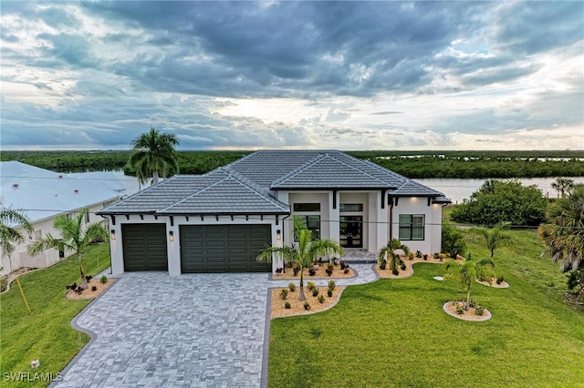 view of front of home with a garage and a front lawn