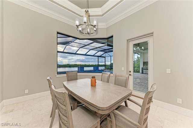 dining room with a chandelier, a water view, and crown molding