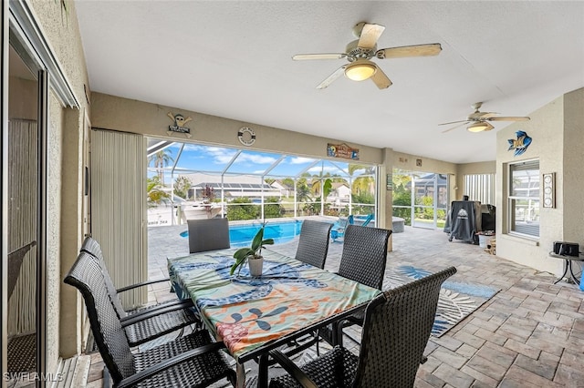 view of patio featuring glass enclosure and ceiling fan