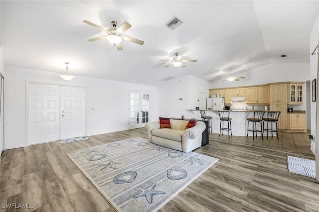 living room with hardwood / wood-style flooring and lofted ceiling