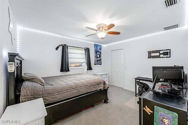 carpeted bedroom with ceiling fan and a closet