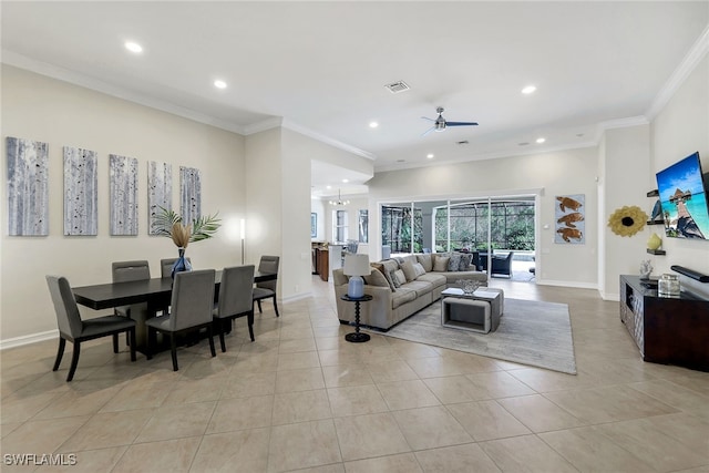 tiled living room featuring ceiling fan with notable chandelier and crown molding