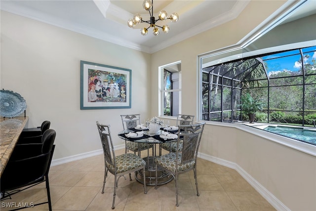 dining room featuring ornamental molding, a notable chandelier, light tile patterned floors, and a tray ceiling