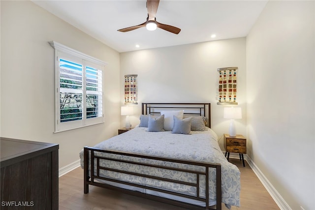 bedroom featuring hardwood / wood-style flooring and ceiling fan