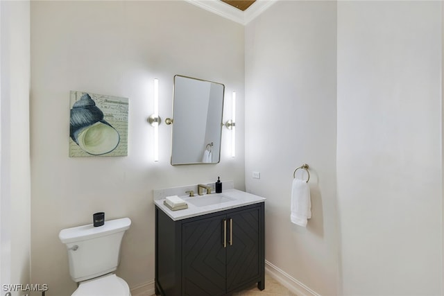 bathroom featuring vanity, toilet, and ornamental molding