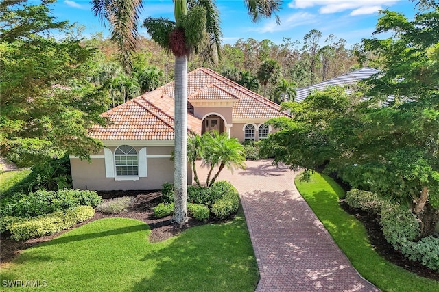 mediterranean / spanish-style home featuring a front yard