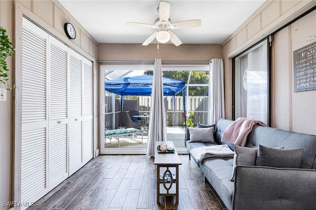 living room featuring dark hardwood / wood-style floors and ceiling fan