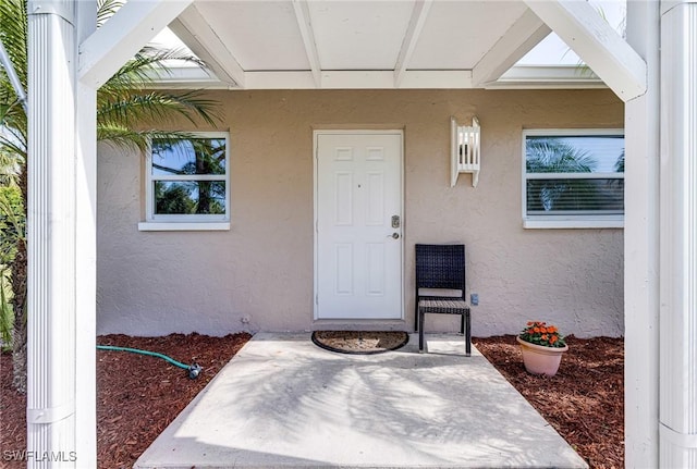 entrance to property featuring a patio