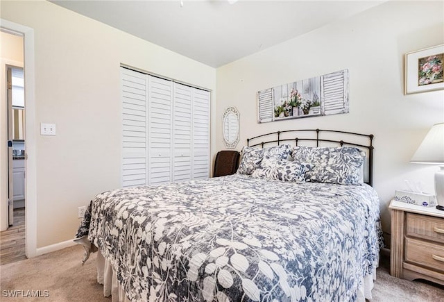 bedroom with light colored carpet and a closet