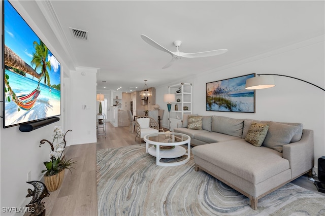 living room featuring ornamental molding, ceiling fan, and light hardwood / wood-style floors