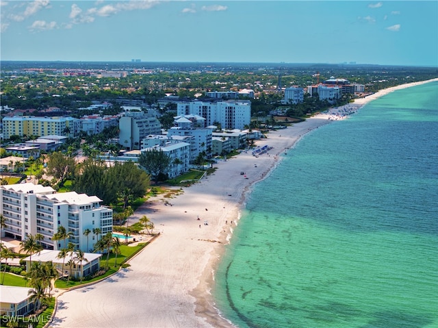 drone / aerial view with a water view and a beach view