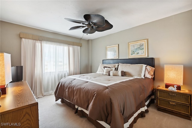 bedroom featuring ceiling fan and light carpet