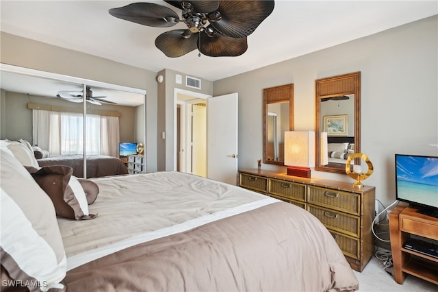 carpeted bedroom featuring ceiling fan and a closet