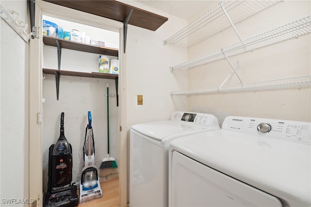 laundry area featuring light wood-type flooring and washing machine and dryer