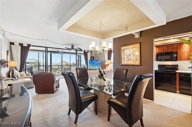 tiled dining room featuring floor to ceiling windows and ceiling fan with notable chandelier