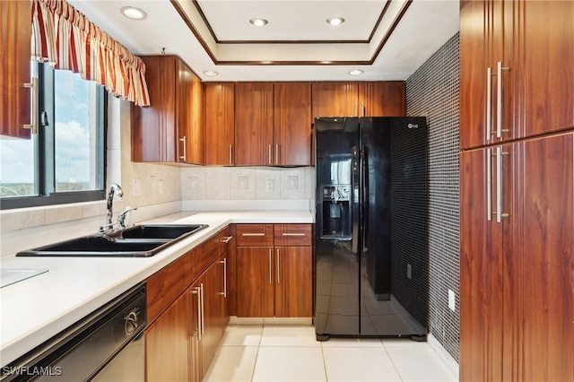 kitchen featuring sink, light tile patterned floors, stainless steel dishwasher, a raised ceiling, and black fridge with ice dispenser