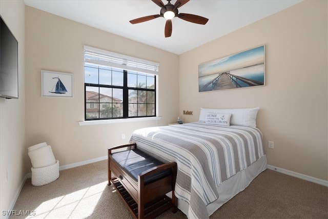 carpeted bedroom featuring baseboards and ceiling fan