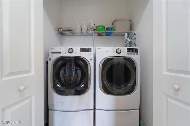 clothes washing area with washing machine and dryer