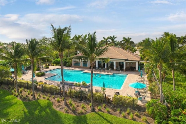 pool with fence and a patio area