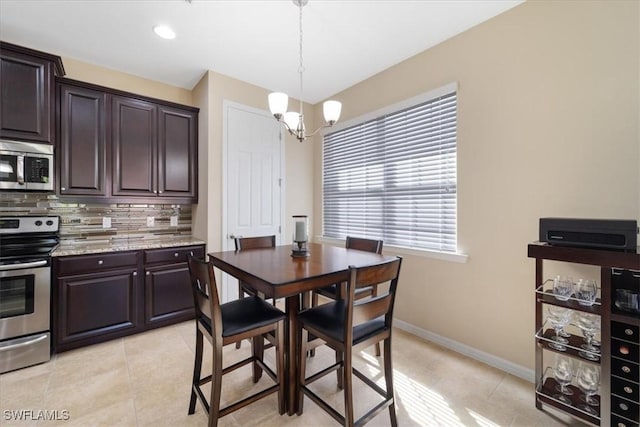 dining room featuring light tile patterned floors, baseboards, a chandelier, and recessed lighting