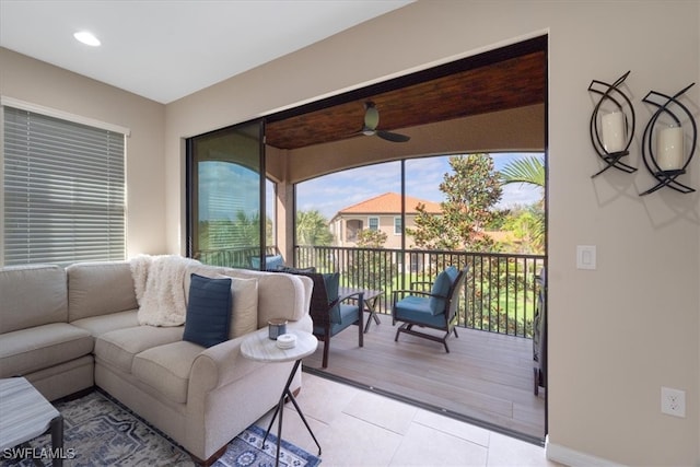 living area with light tile patterned floors, a ceiling fan, recessed lighting, and baseboards