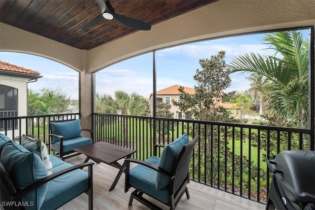 deck with outdoor lounge area, area for grilling, and a ceiling fan