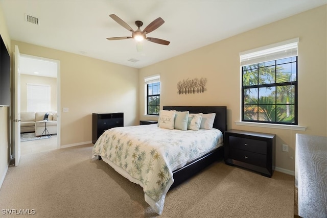 bedroom featuring light colored carpet and ceiling fan