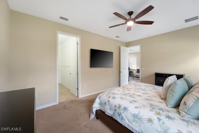 bedroom featuring visible vents, light carpet, baseboards, and ceiling fan