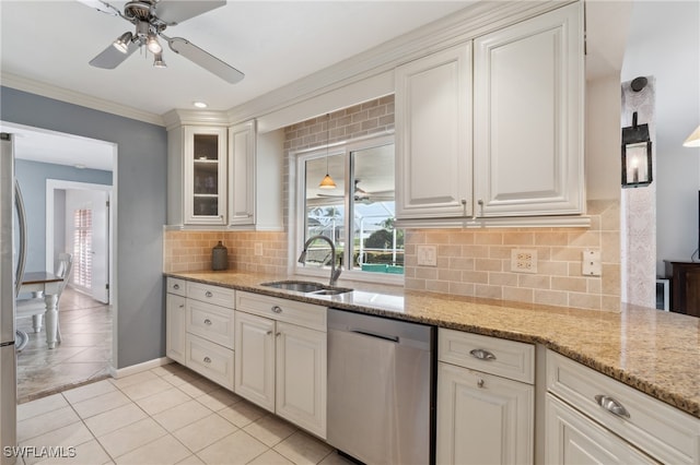 kitchen featuring sink, tasteful backsplash, light stone counters, white cabinetry, and stainless steel appliances