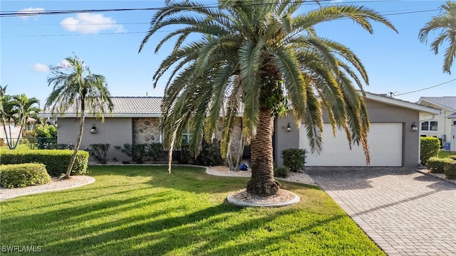 view of front of home with a front yard and a garage