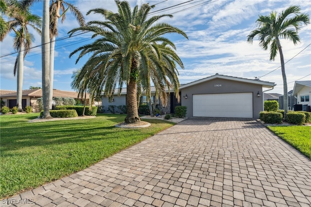 view of front of house with a garage and a front lawn