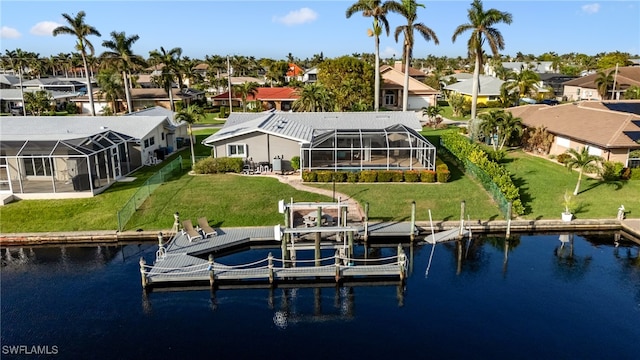 view of dock featuring a lanai, a yard, and a water view