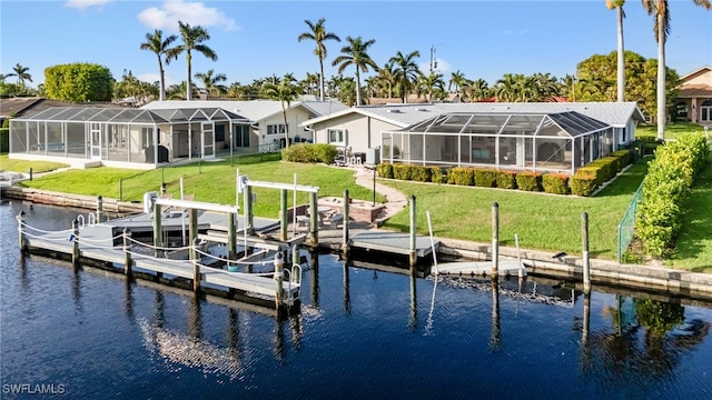 dock area with a yard, a water view, and a lanai