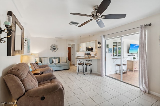 living room with ceiling fan and light tile patterned floors