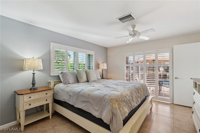 tiled bedroom featuring ceiling fan, access to outside, and multiple windows