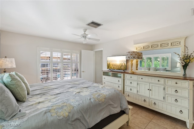 bedroom with ceiling fan and light tile patterned flooring