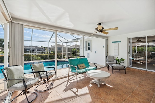 sunroom / solarium featuring ceiling fan