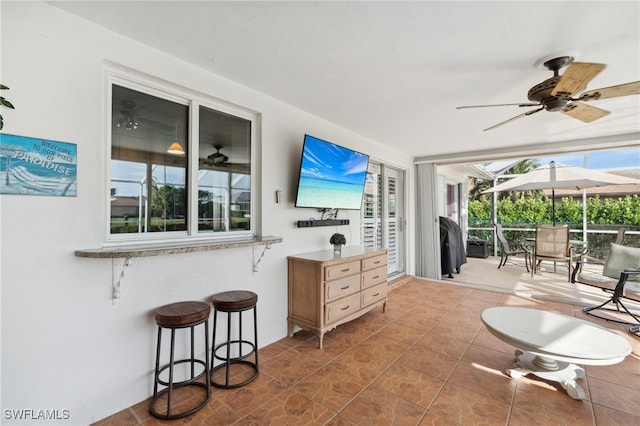 interior space with ceiling fan