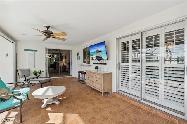 living area featuring ceiling fan