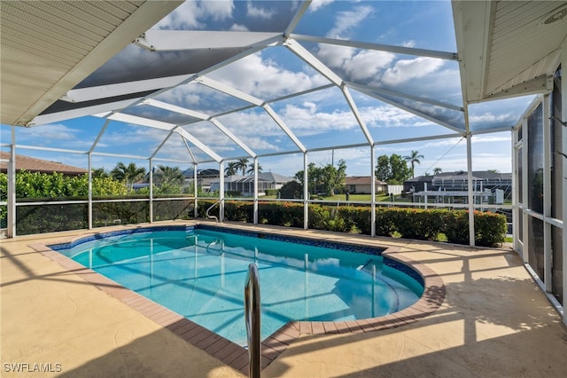 view of swimming pool featuring a patio area and a lanai