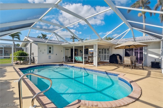 view of pool featuring a patio area, ceiling fan, and a lanai