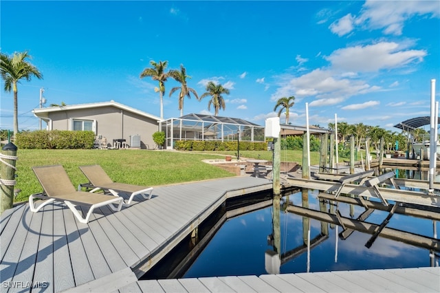 dock area with a lawn, glass enclosure, and a water view