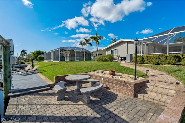 view of patio with a lanai and central AC