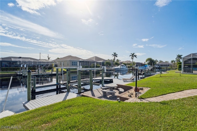 dock area with a yard and a water view