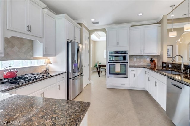 kitchen with white cabinets, hanging light fixtures, sink, and appliances with stainless steel finishes